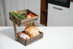 handmade kraft box with fruits and vegetables on kitchen background. photo