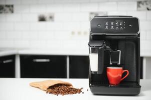 Modern espresso coffee machine with a cup in kitchen photo