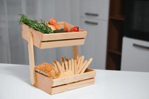 Craft wooden plate for storing bread or vegetables in the kitchen photo