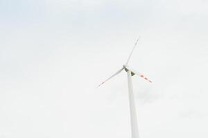 Windmill against cloudy sky with copyspace photo