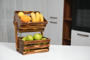 handmade kraft box with fruits and vegetables on kitchen background. photo