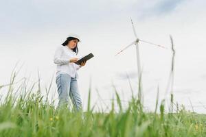 researcher analyzes readouts on wind power station photo