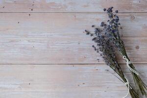 Dried lavender flowers on wooden background. Copy space for your text. Advertisement mock up template photo