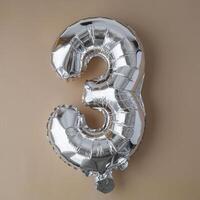 3 three metallic balloon on beige neutral background. Greeting card silver foil balloon number Happy birthday holiday concept. Copy space for text. Celebration party congratulation decoration photo