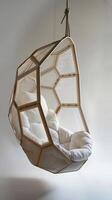 AI generated Hanging Chair with Geometric Design, A cocoon-like hanging chair suspended from the ceiling with geometric, overlapping panels made of translucent woven wood, generative AI photo