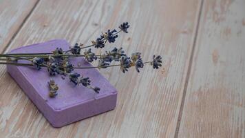 Lavender soap on wooden background with copy space for your text. Advertisement template mock up. Skincare homemade natural cosmetic concept. Organic dry lavender flower. Handmade soap photo