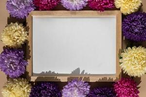 Holiday postcard greeting card empty paper note frame around mixed colorful flowers. Copy space mockup template. Advertisement sample photo