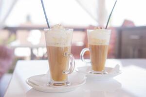 coffee is served in a tall glass glass with a straw. The concept of coffee drinks from the bar menu photo