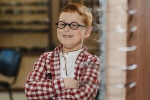 boy in glasses , at optics store. photo