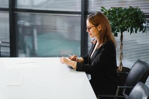 beautiful young woman on the workplace using a digital tablet photo