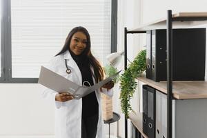 medicine, people and healthcare concept - african american female doctor or nurse at hospital. photo