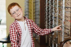 boy in glasses , at optics store. photo