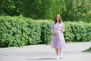 Pregnant woman resting in the park photo