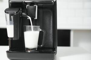 Home professional coffee machine with cappuccino cup. coffee machine latte macchiato cappuccino milk foam prepare concept photo