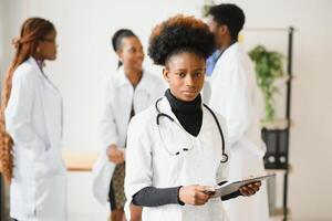 Portrait of a smiling nurse in front of her medical team. photo