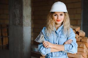 Warehouse woman worker. Woman builder in hardhat. Girl engineer or architect. Home renovation. Quality inspector. Construction job occupation. Construction worker. Lady at construction site photo