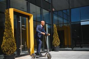 Young African businessman Riding An Electric Scooter photo