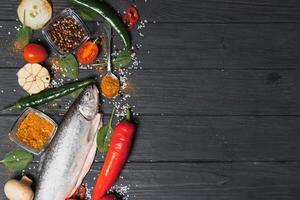 fresh trout with spices and seasonings top view, flat lay photo