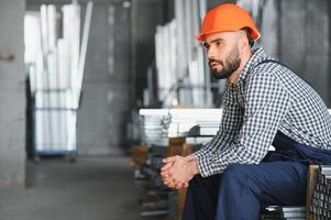 Man chooses metal profile for construction in Factory photo