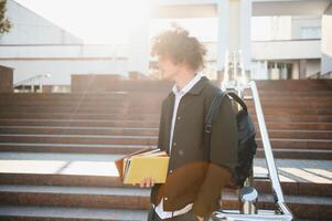 Excited student having break between classes near university, smiling to camera outdoors photo