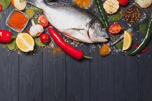 Fresh rainbow trout with spices and ingredient for cooking photo