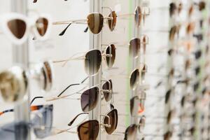 fashionable sunglasses on the shop shelf. photo