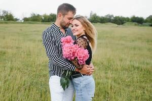 Young couple walks in the park during the spring and hugs. Enjoying time together. The concept of youth, love and lifestyle photo