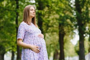 Pregnant woman resting in the park photo