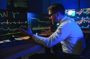 Financial Analysts and Day Traders Working on a Computers with Multi-Monitor photo