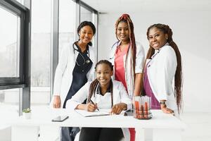 group of young african medical workers on white background. photo