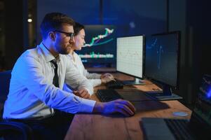 Business team investment working with computer, planning and analyzing graph stock market trading with stock chart data photo