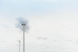 Windmill against cloudy sky with copyspace photo