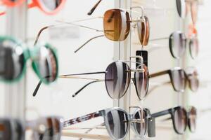 fashionable sunglasses on the shop shelf. photo