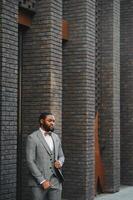 Portrait of an African American businessman wearing a suit standing in an outdoor business environment photo