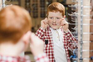 boy in glasses , at optics store. photo