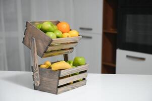 handmade kraft box with fruits and vegetables on kitchen background. photo