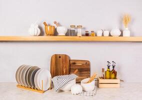 Front view of an open wooden shelf and kitchen countertop with eco-friendly kitchen utensils. Eco-friendly kitchen photo