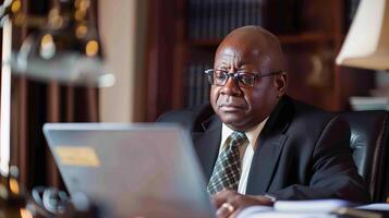 AI generated Focused at Work, a business man seated at a desk, working on his laptop or reviewing documents, generative AI photo