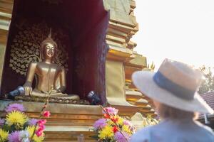 Traveler Asian woman traveling and walking in Bangkok Chiang Mai Temple, Thailand, backpacker female feeling happy spending relax time in holiday trip photo