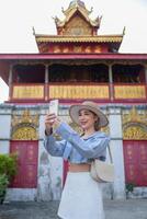 Traveler Asian woman traveling and walking in Bangkok Chiang Mai Temple, Thailand, backpacker female feeling happy spending relax time in holiday trip photo