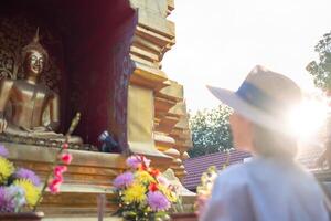 Traveler Asian woman traveling and walking in Bangkok Chiang Mai Temple, Thailand, backpacker female feeling happy spending relax time in holiday trip photo