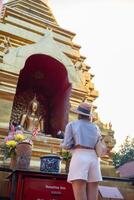 Traveler Asian woman traveling and walking in Bangkok Chiang Mai Temple, Thailand, backpacker female feeling happy spending relax time in holiday trip photo