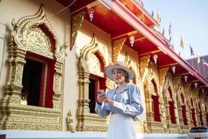 Traveler Asian woman traveling and walking in Bangkok Chiang Mai Temple, Thailand, backpacker female feeling happy spending relax time in holiday trip photo