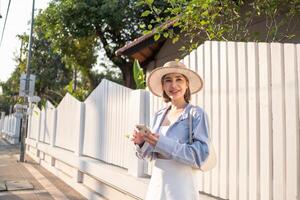 Traveler Asian woman traveling and walking in Bangkok Chiang Mai Temple, Thailand, backpacker female feeling happy spending relax time in holiday trip photo