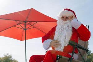 Santa Claus on the seashore. Christmas in the tropics photo