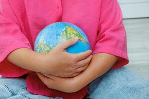 woman carefully hugs the globe photo