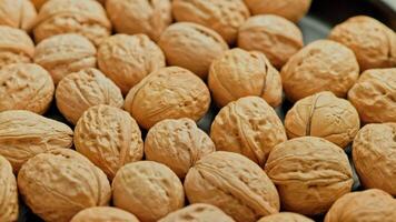 looped spinning walnuts with shells close-up full frame background video