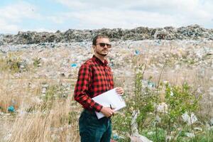 Garbage dump inspector records pollution level. Ecology pollution concept. Save planet photo