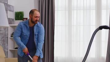 Young family cleaning their apartment using vacuum cleaner. video