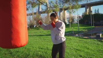 a woman is practicing boxing in the park video